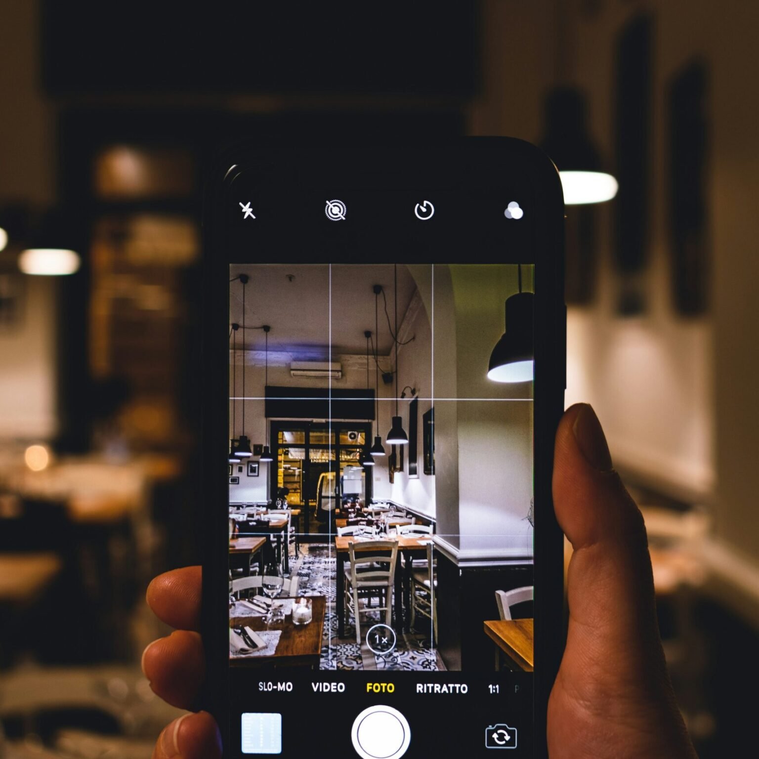 Smartphone capturing interior content for digital campaigns often featured in RevampX creative marketing strategies.