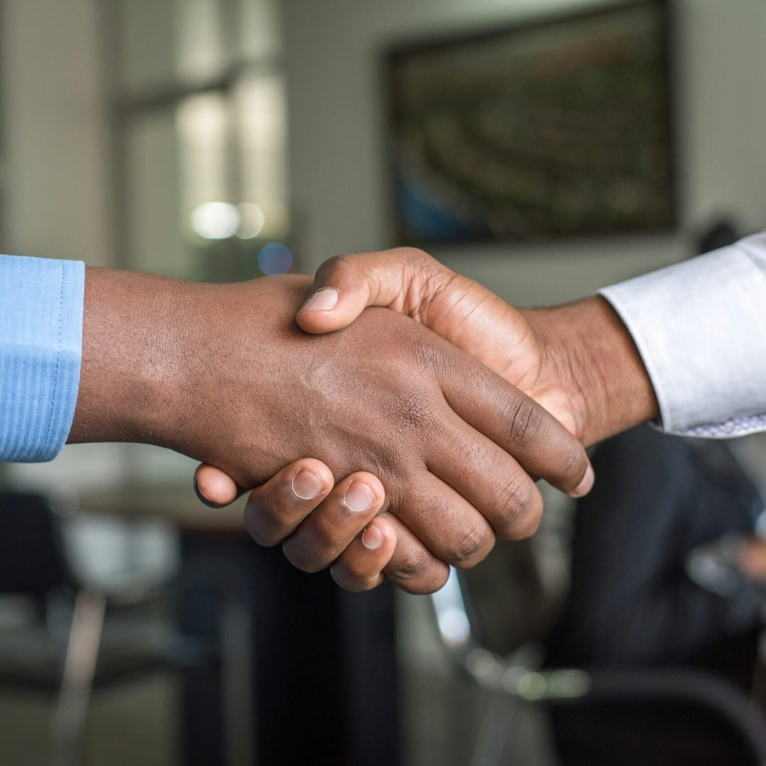 Professional handshake symbolizing a strategic business partnership guided by RevampX consulting expertise.