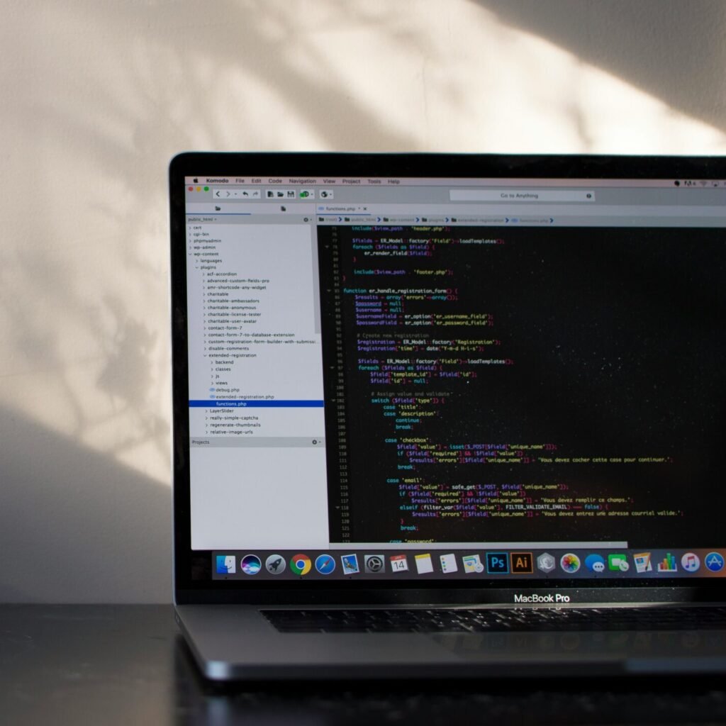Website development code displayed on a MacBook screen showcasing professional backend design similar to RevampX web developers.