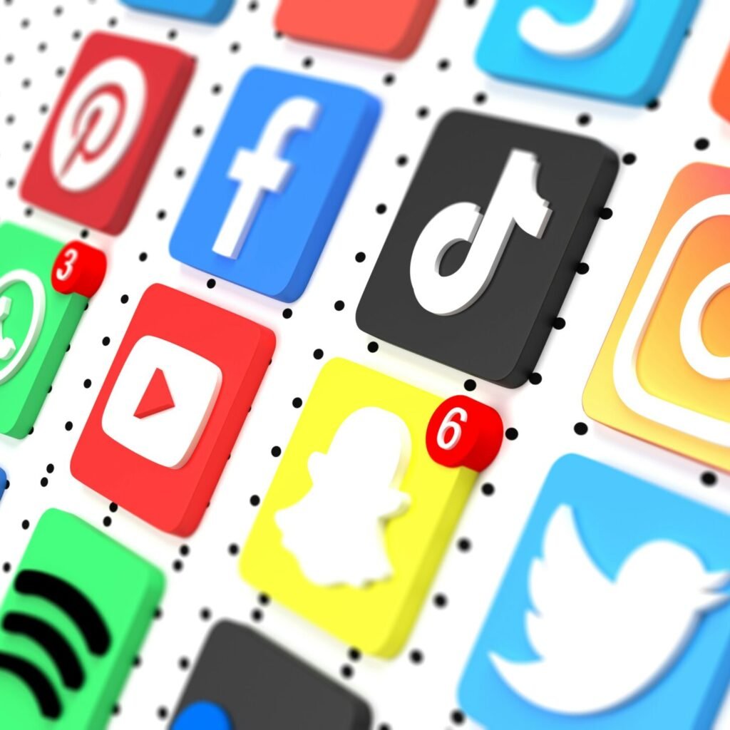 Close-up of popular social media app icons on a dotted background, representing digital engagement strategies supported by RevampX.